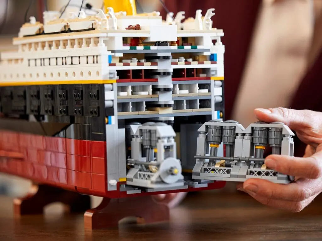 Hands holding LEGO ship engine section