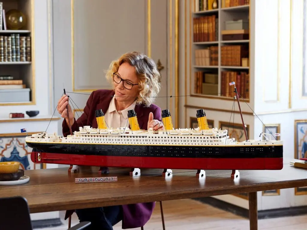 Person assembling Titanic model ship