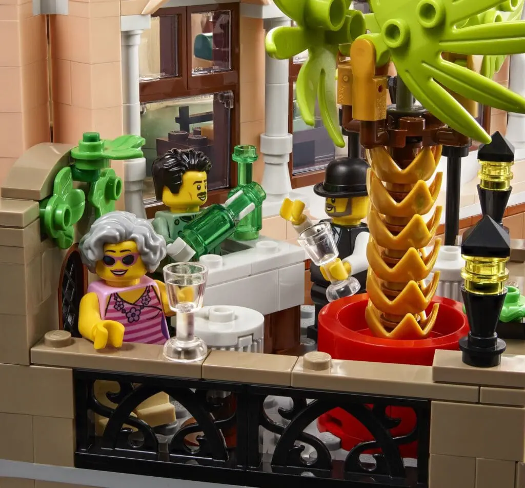 LEGO figures enjoying drinks on a terrace.