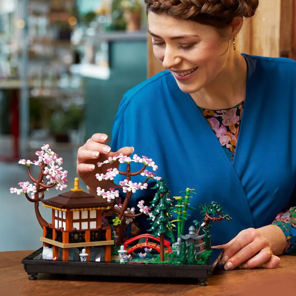 Woman interacting with detailed model garden