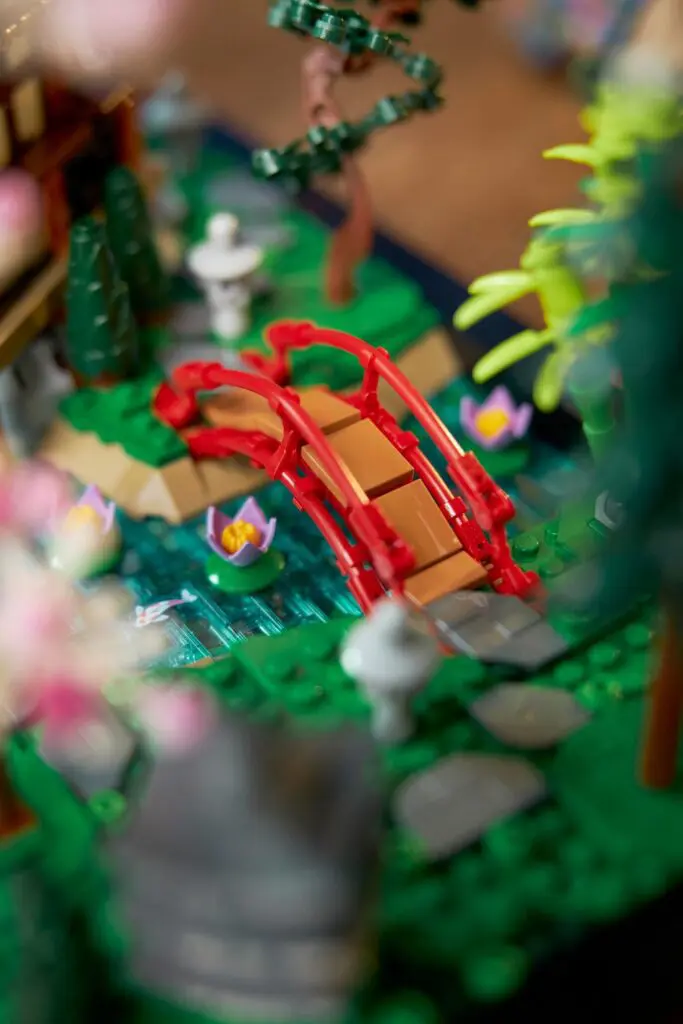Miniature red bridge over blue stream