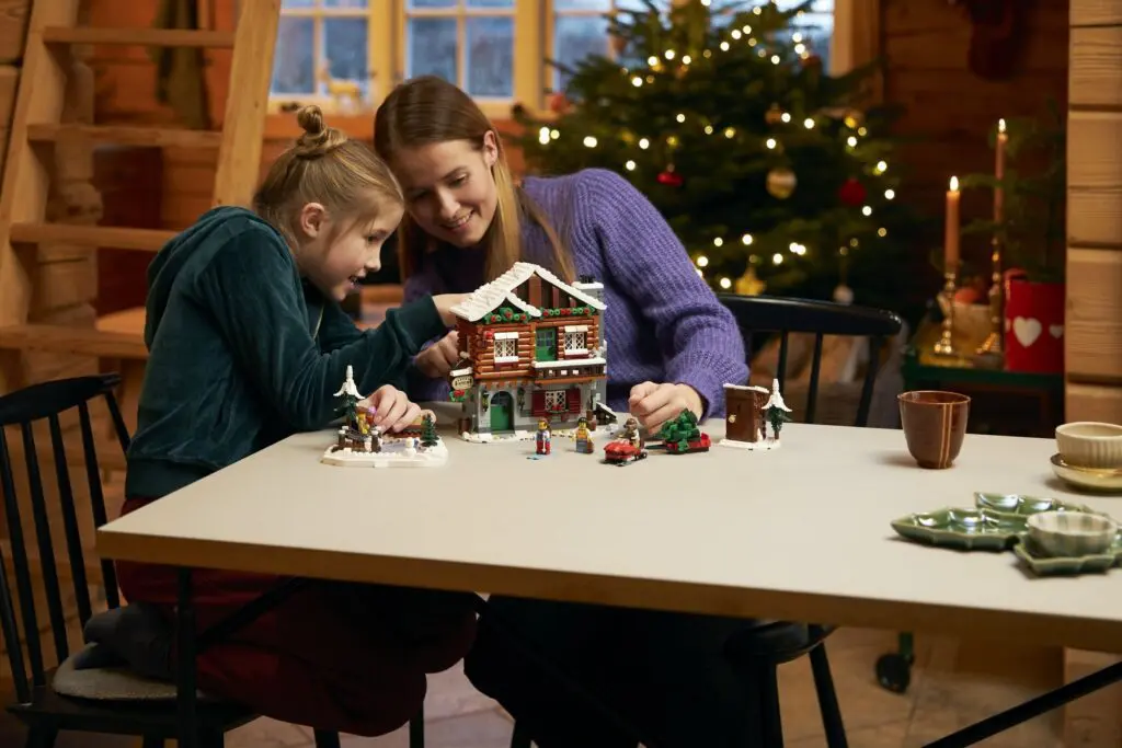 Mother and daughter building holiday model house