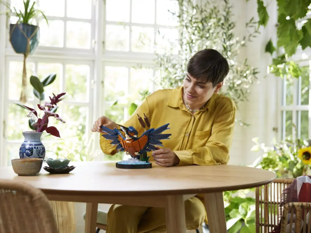 Individual in yellow building bird sculpture