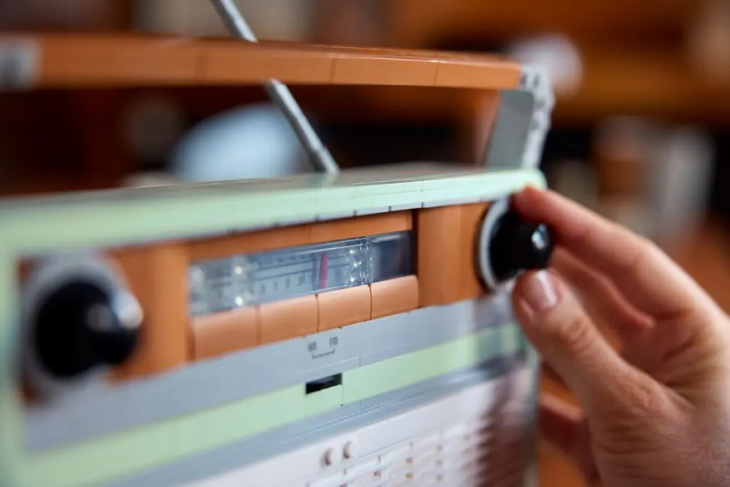 Hand tuning a retro radio dial
