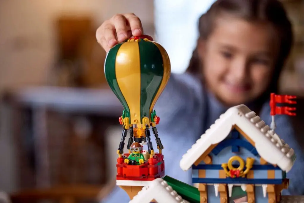 Smiling kid with toy balloon set