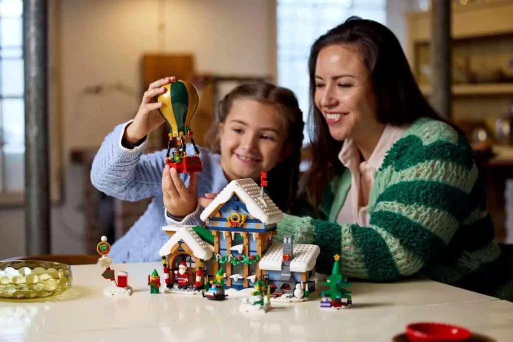 Smiling pair assembling Lego house set