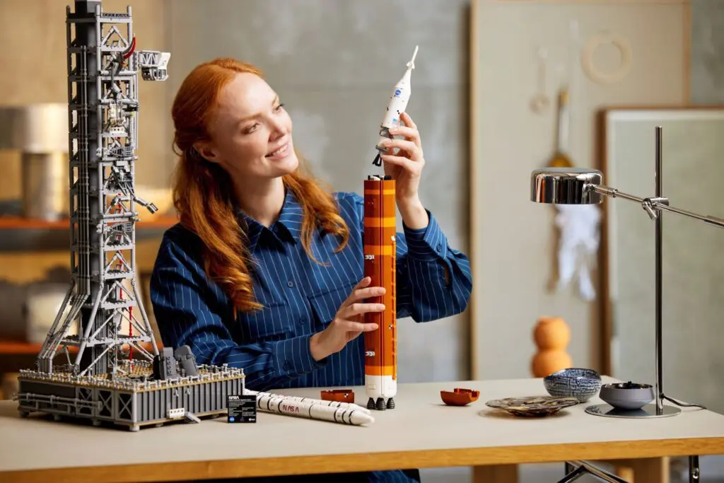 Person constructing launch tower and rocket