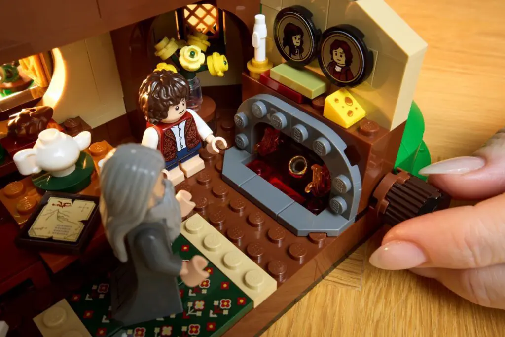 Hands adjusting LEGO scene with figures