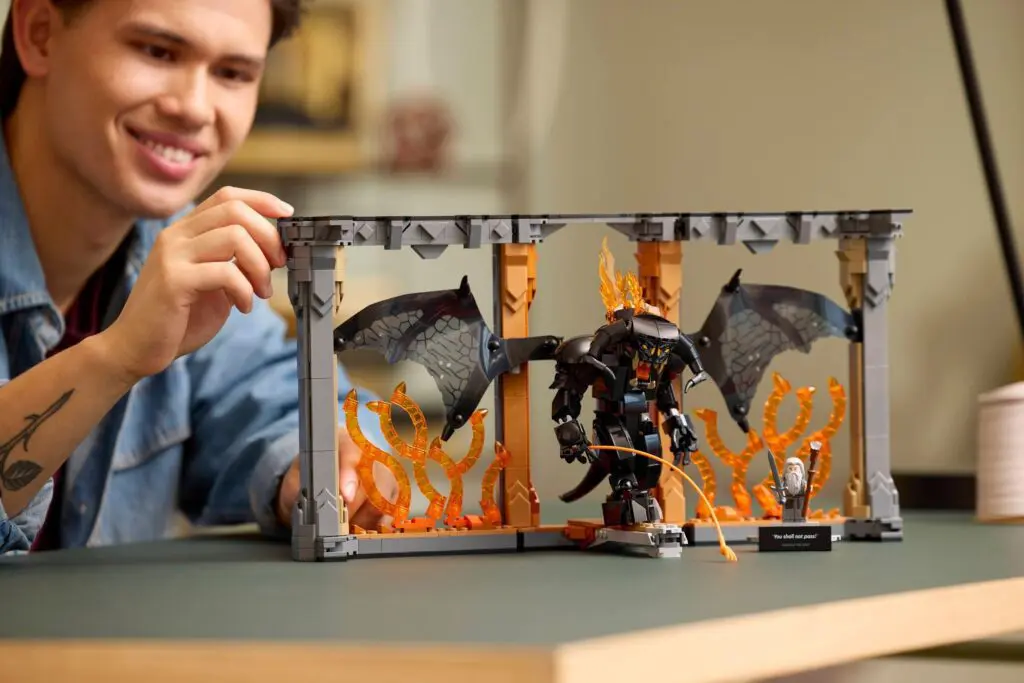 Smiling individual with LEGO set