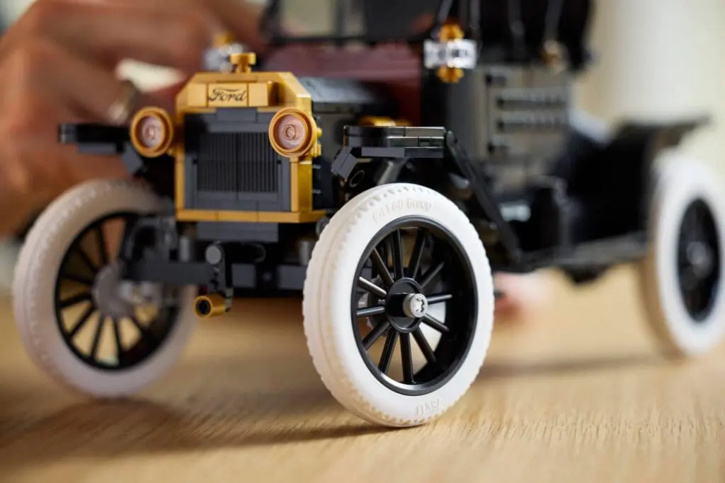 Hand assembling LEGO vintage vehicle