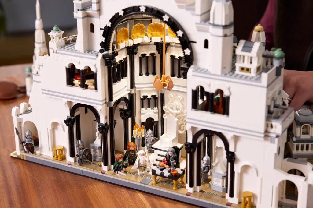Hands assembling LEGO castle structure
