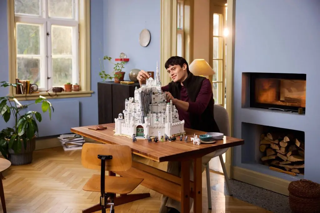 Person building a miniature castle indoors
