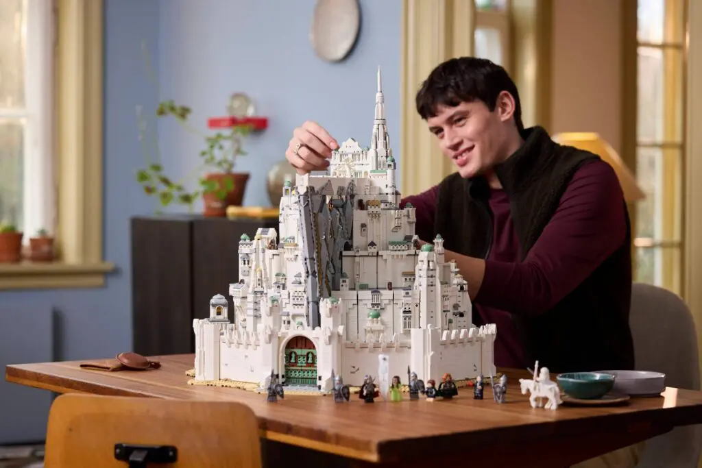 Person assembling intricate castle set indoors