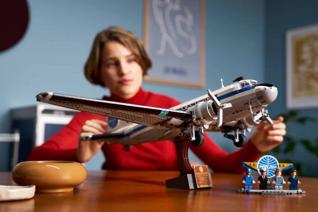 Woman assembling detailed model airplane