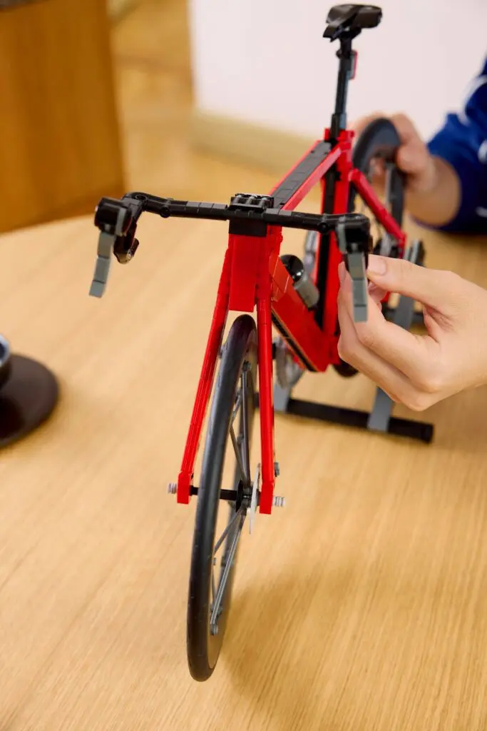 Hands adjusting toy bike handlebars