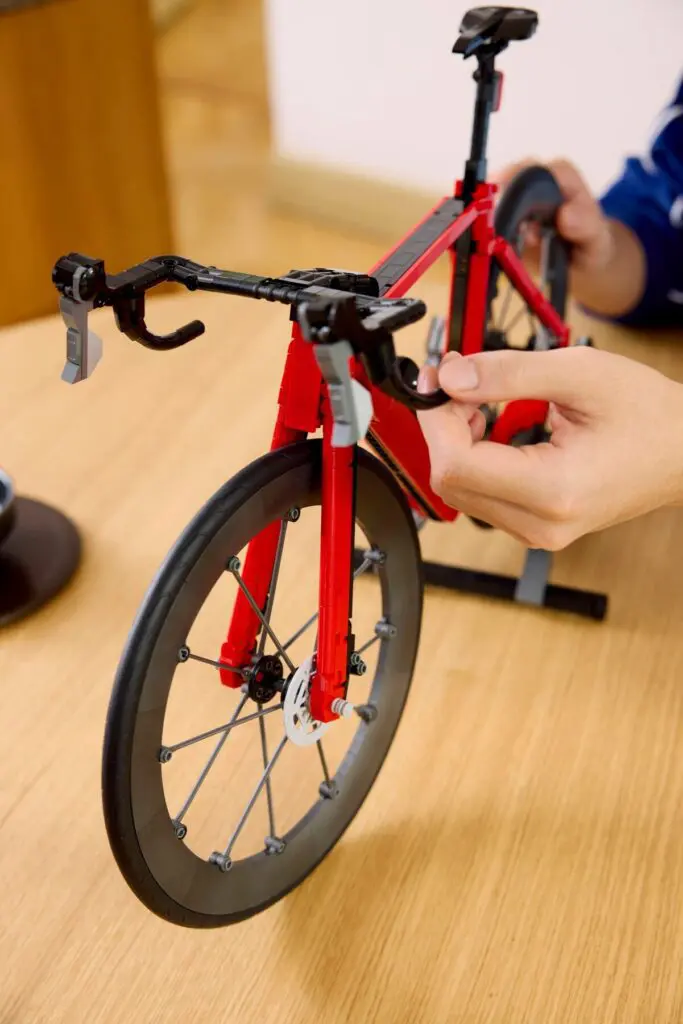 Red toy bicycle being assembled