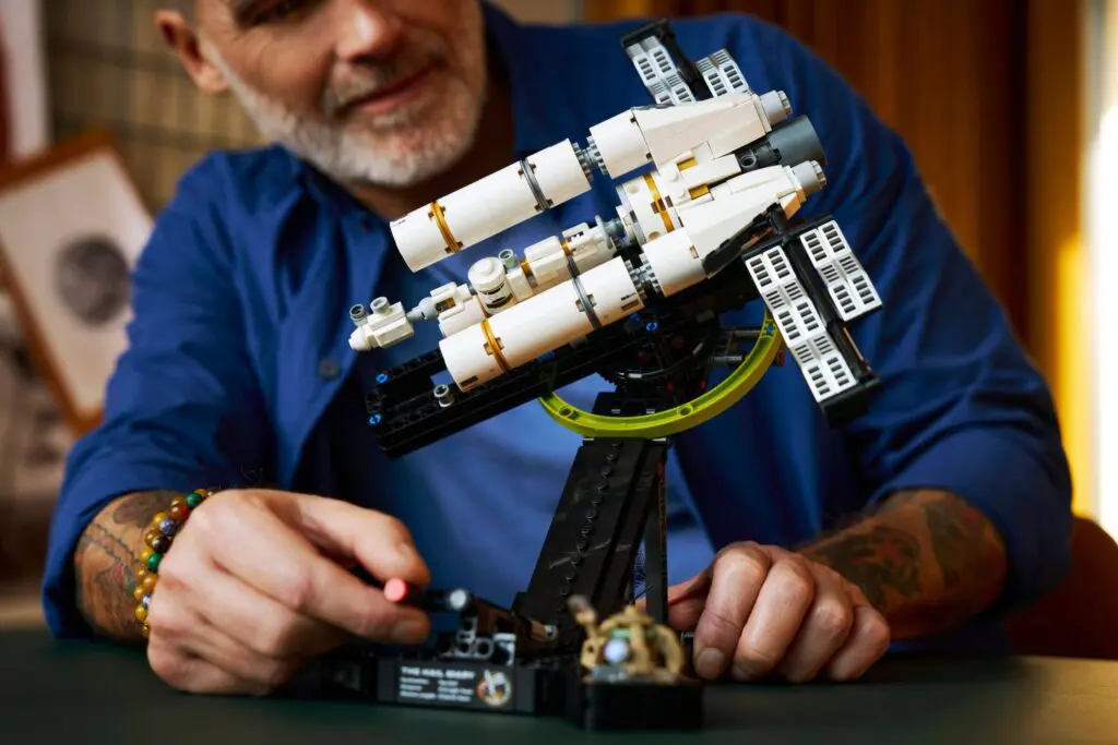 Person building a space-themed toy