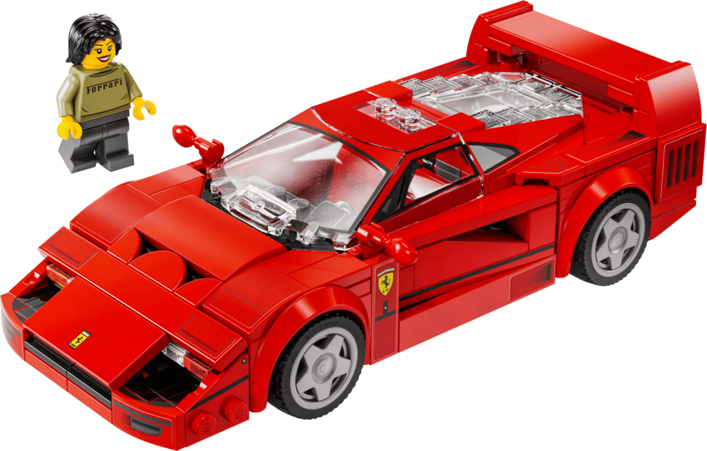Minifigure beside red toy car