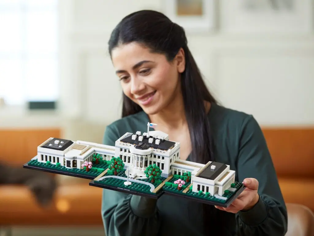 Person showing detailed miniature building model