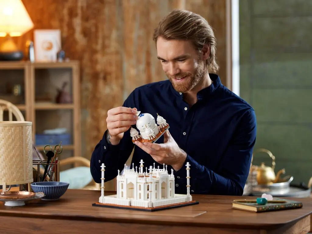 Person constructing a small architectural replica