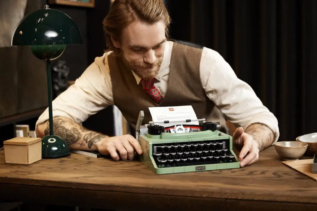 Man using vintage typewriter at desk