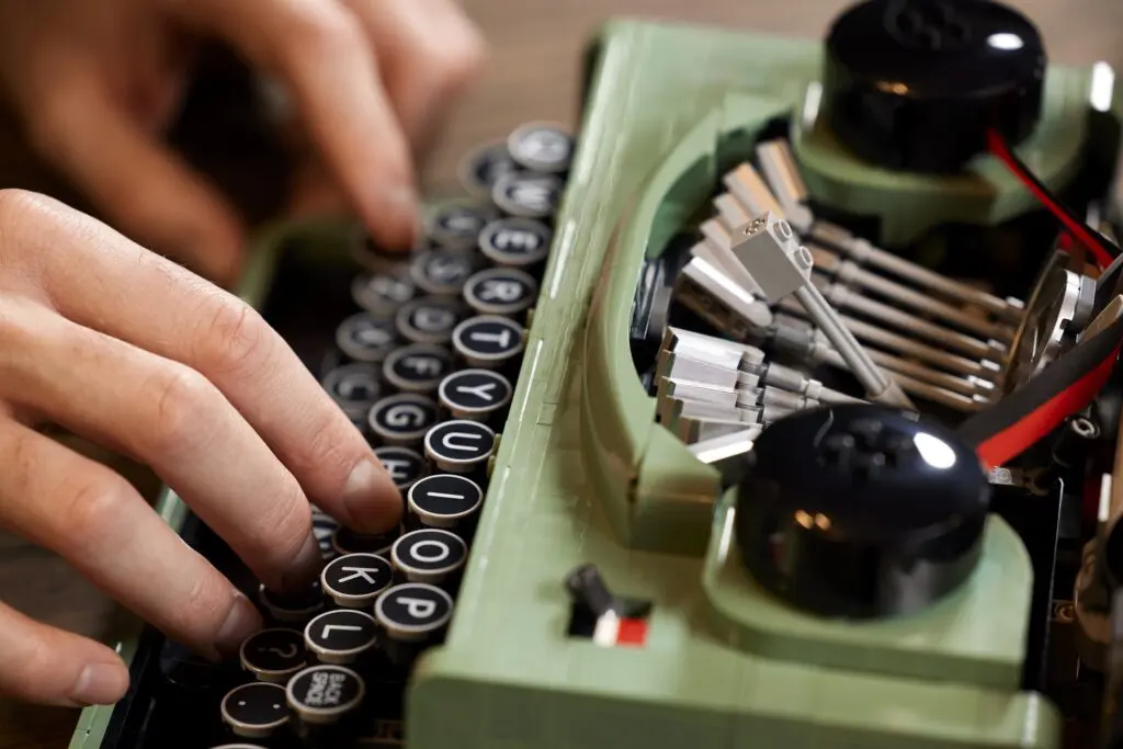 Close-up of fingers on typewriter keys