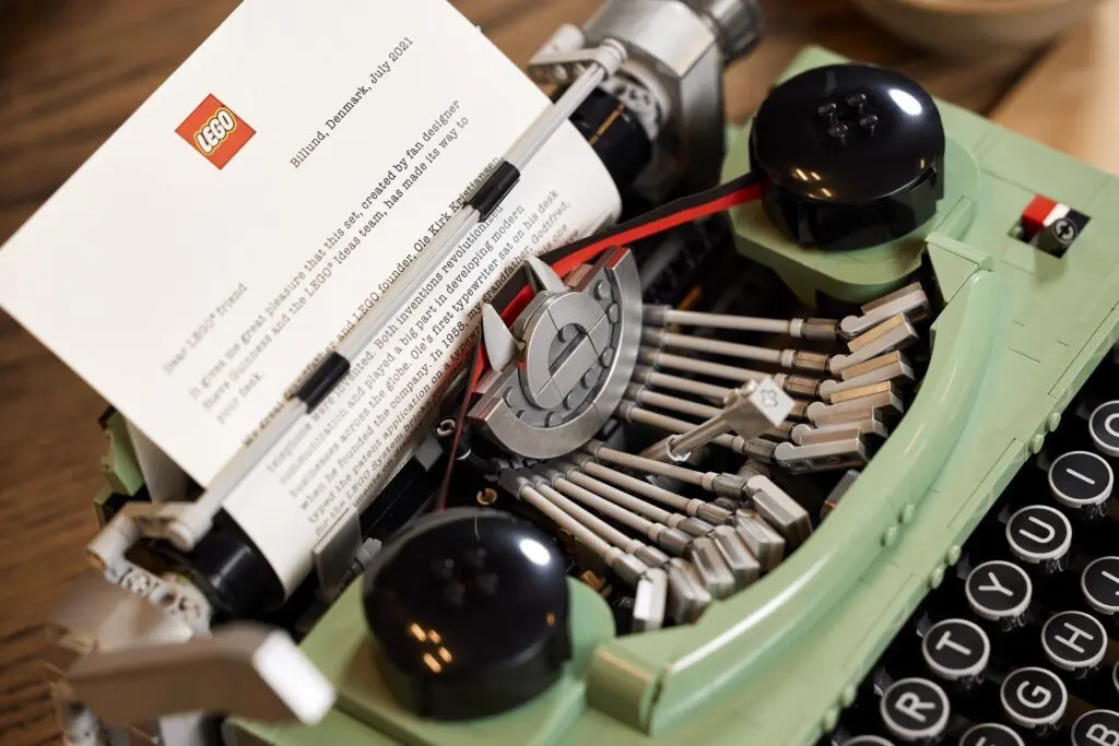 Green typewriter with paper inserted