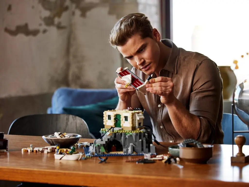 Man assembling detailed Lego structure