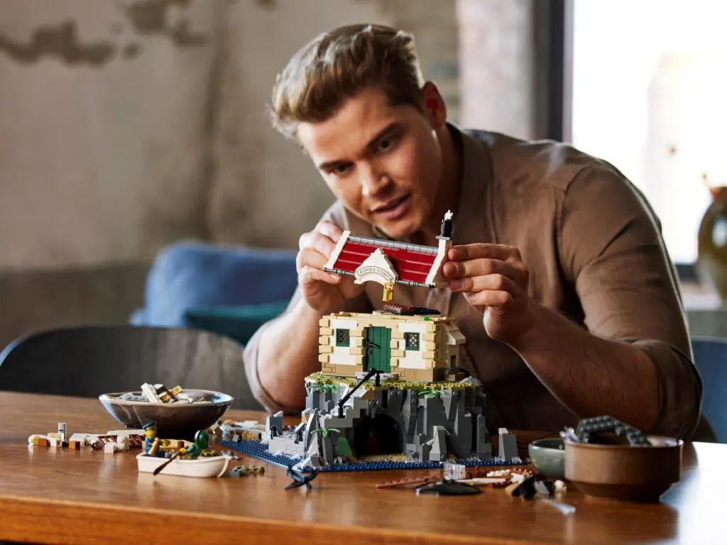 Man building a detailed LEGO set