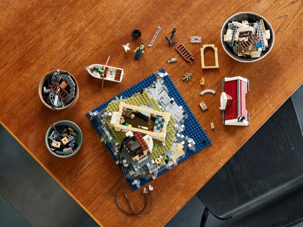 LEGO pieces and model on wooden table