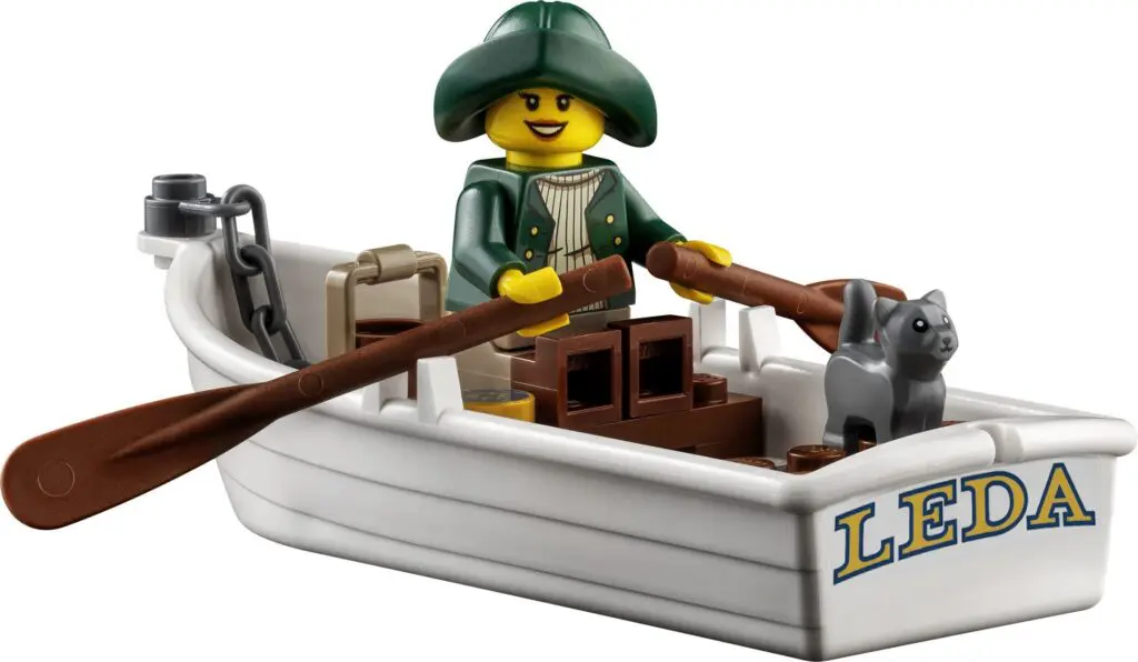 Miniature boat with LEGO sailor figure