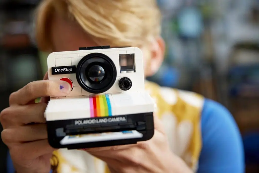 Person holding a vintage instant camera