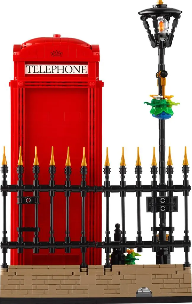 Miniature red telephone box with fence