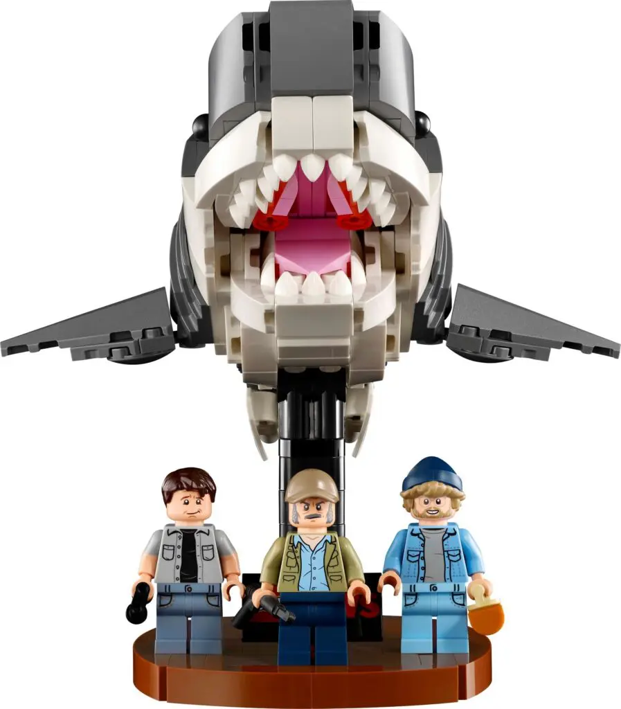 Toy shark and minifigures on stand