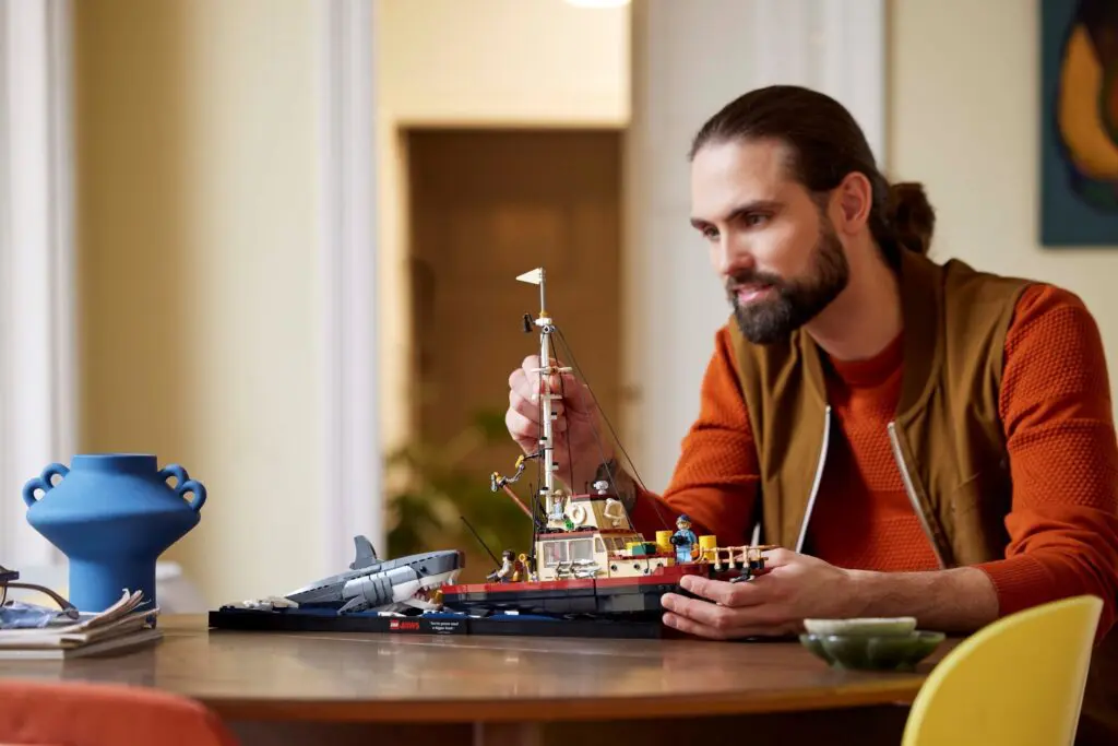 Individual constructing detailed model on table