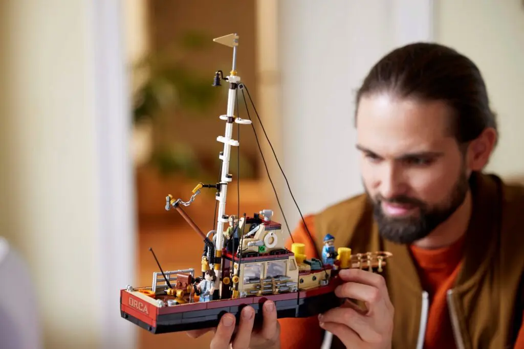 Man holding detailed model ship