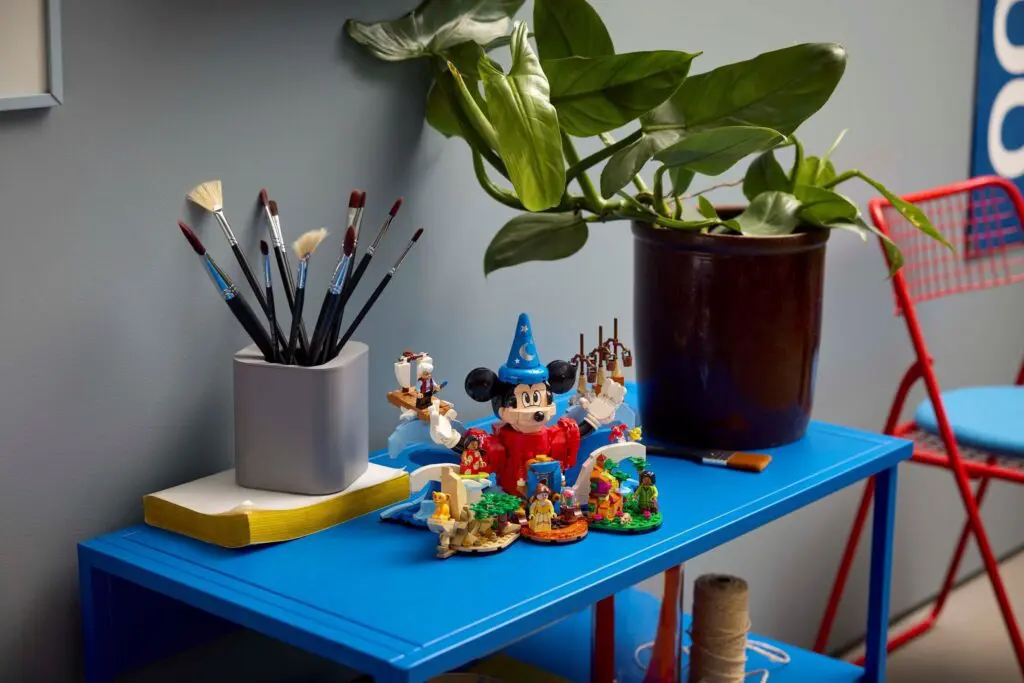 Art supplies and plant on blue table