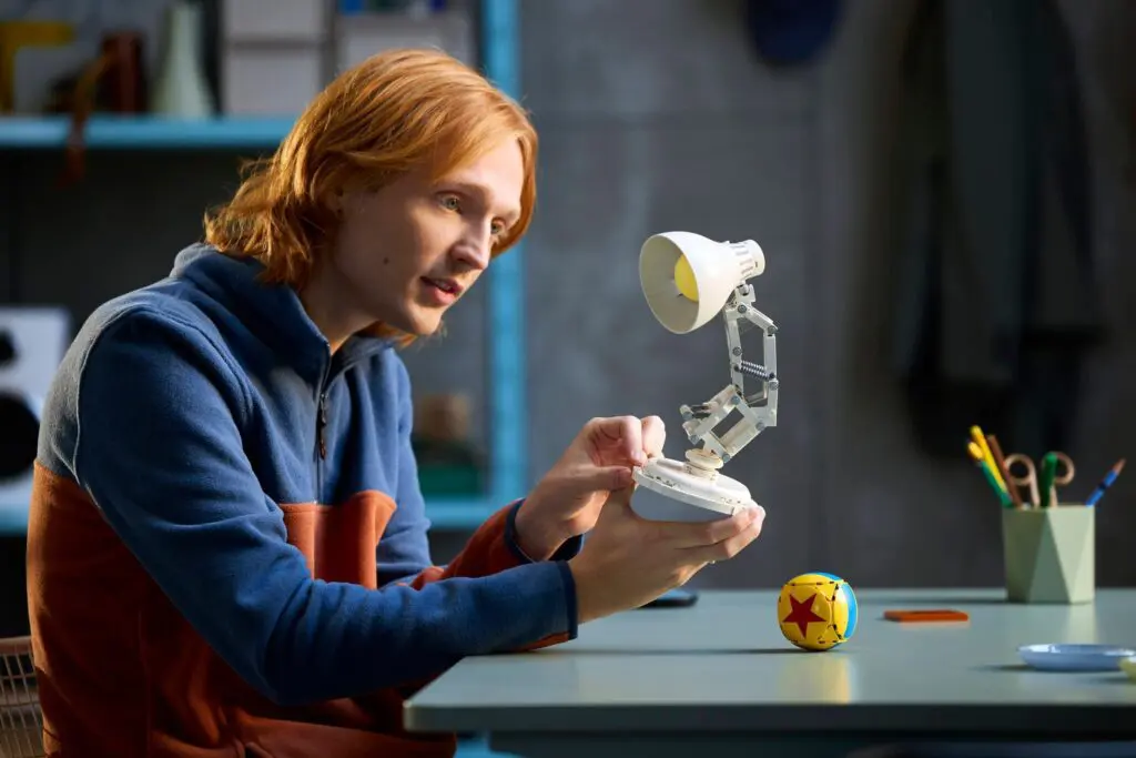 Individual inspecting a mechanical lamp device