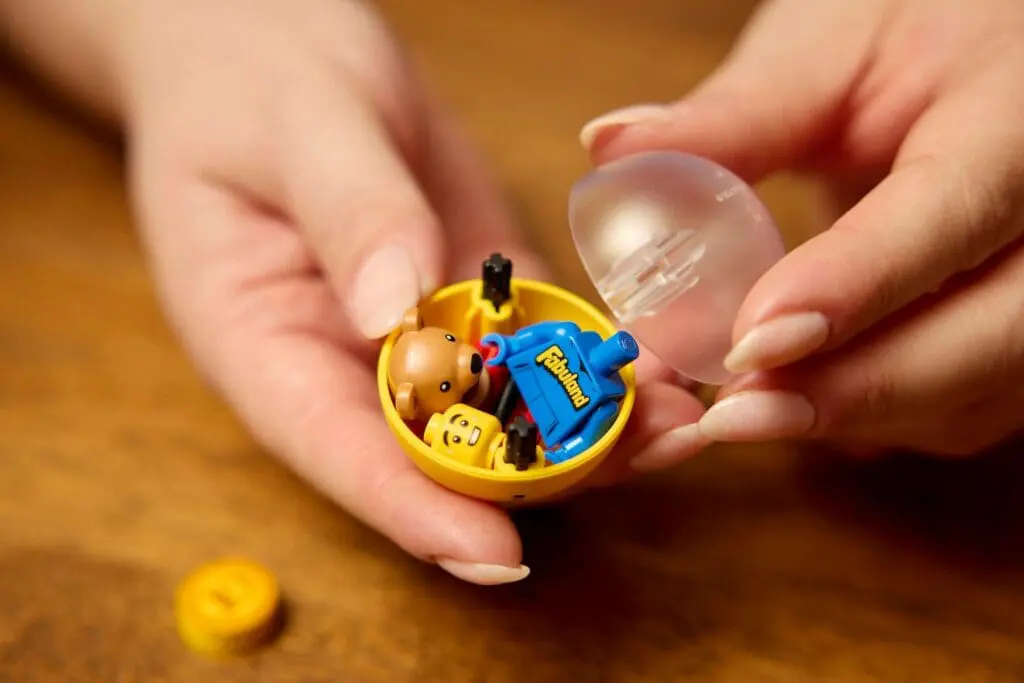 Toy figures in yellow plastic capsule