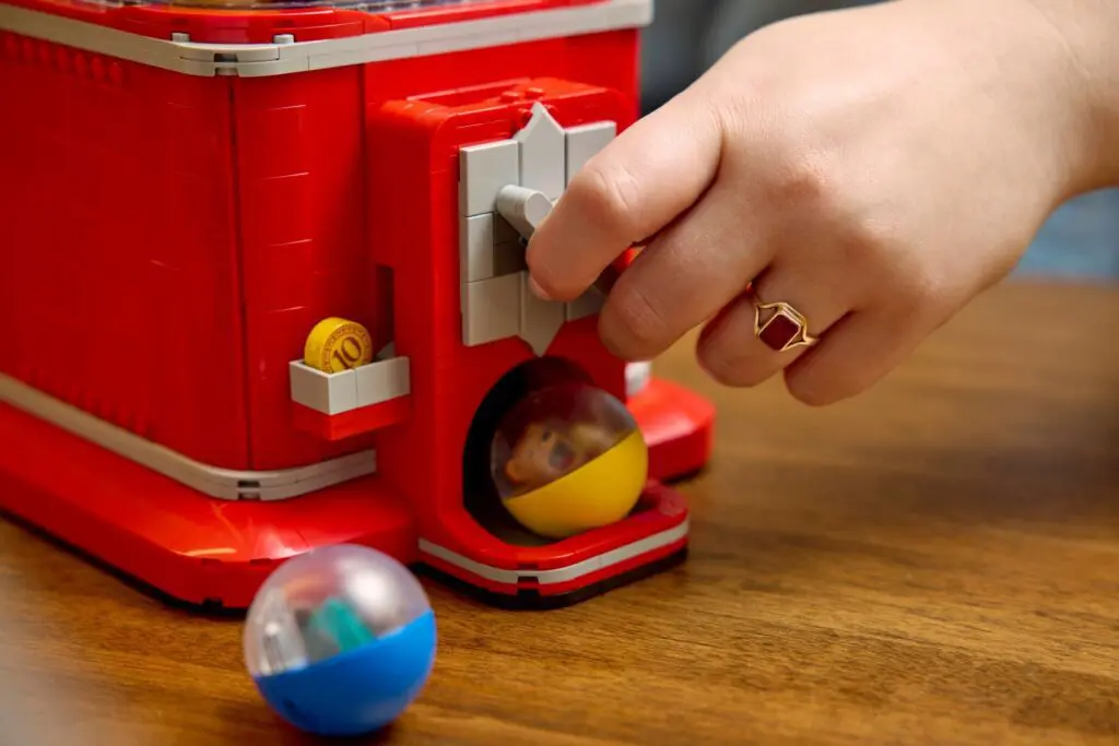 Person turning knob on toy dispenser