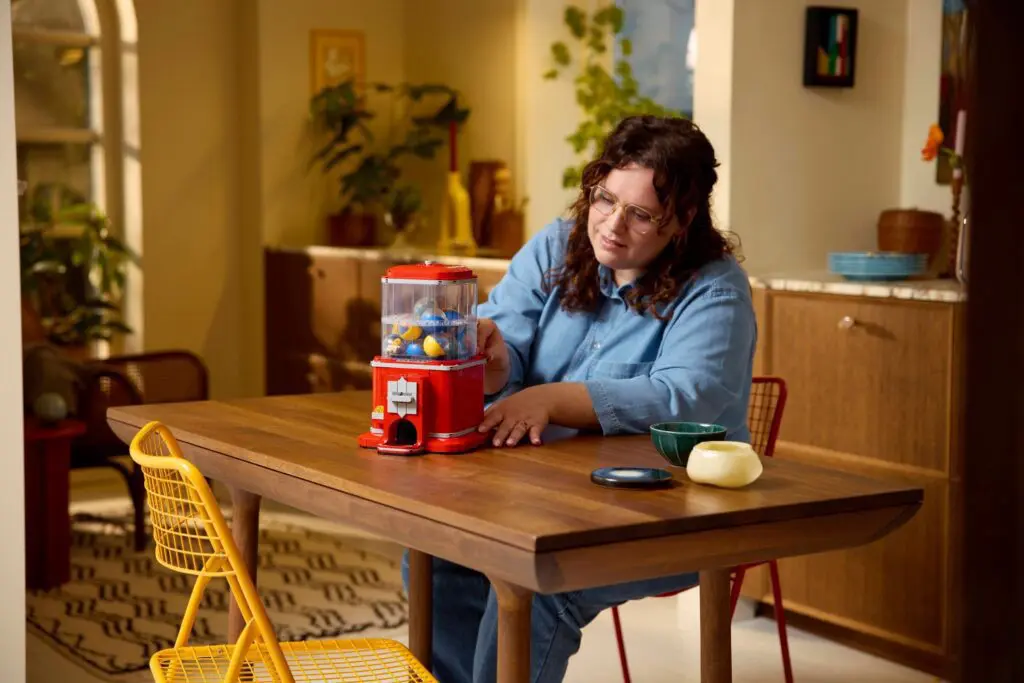 Person in cozy kitchen with red dispenser