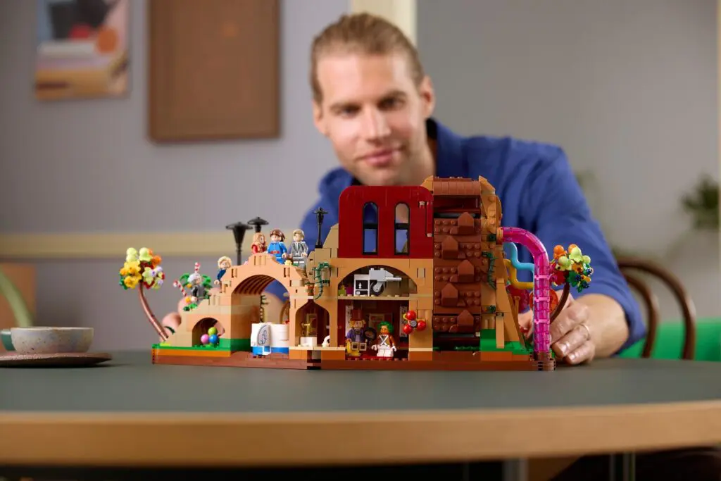 Man enjoying LEGO creation on table