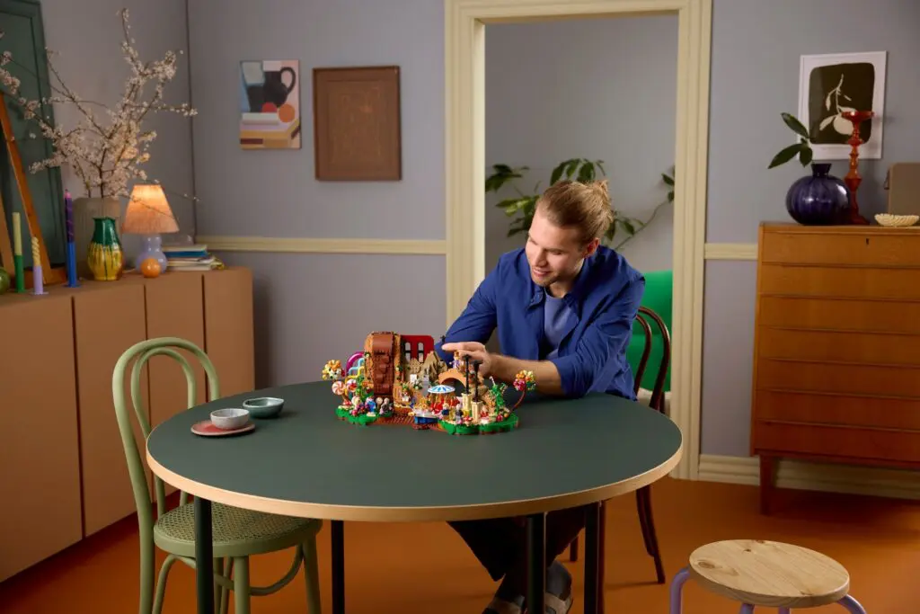 Person building toy in cozy room.