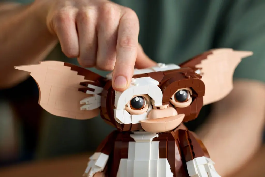 Brown and white Lego figure being touched