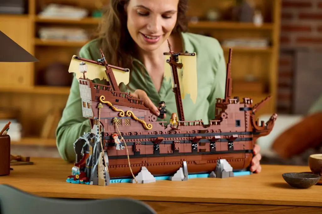Smiling woman building a Lego pirate ship