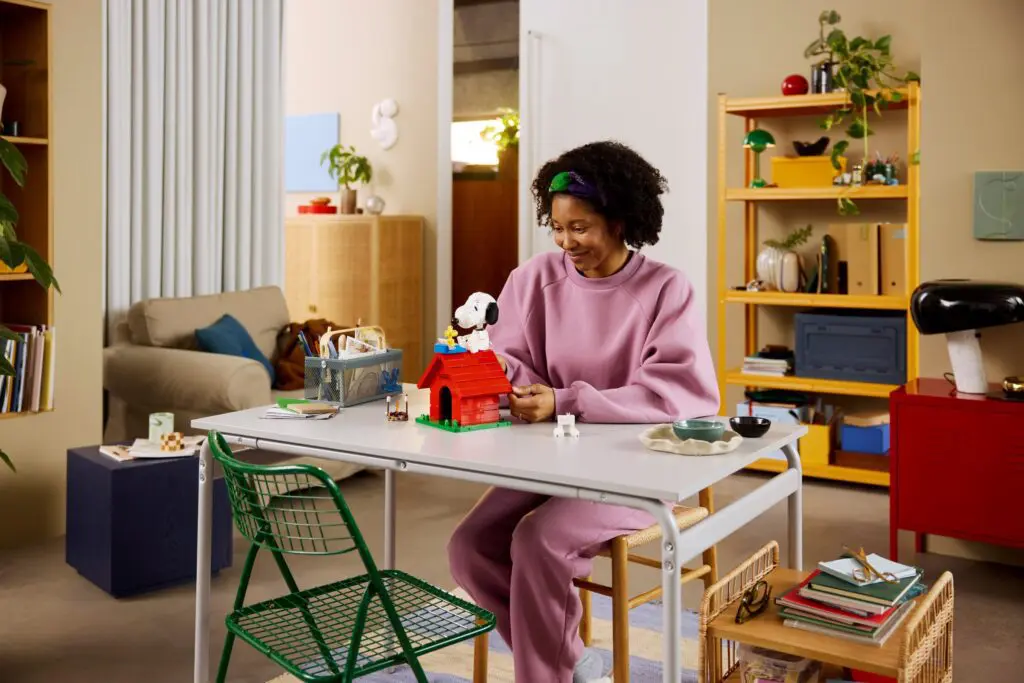 Smiling woman crafting in colorful living space