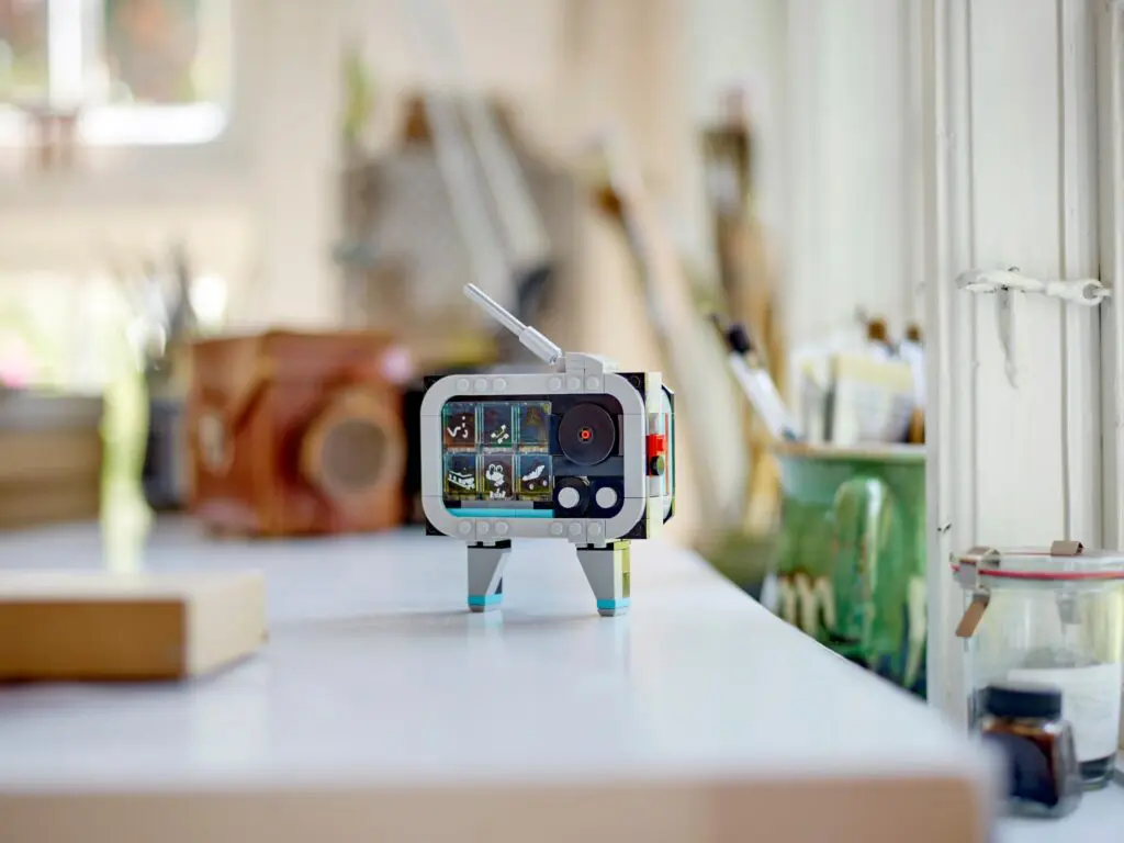 Miniature retro TV on a white table.