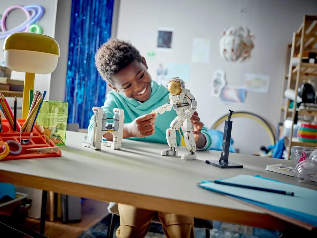 Boy assembling space-themed model kit