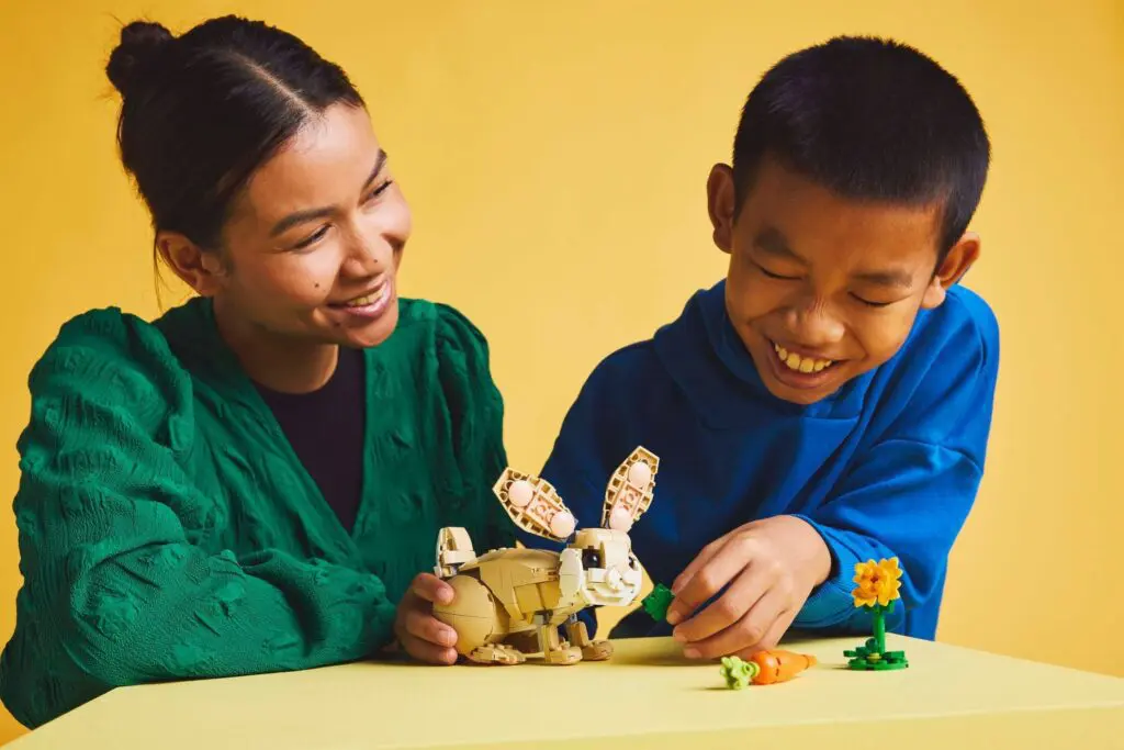 Boy and woman enjoying building blocks