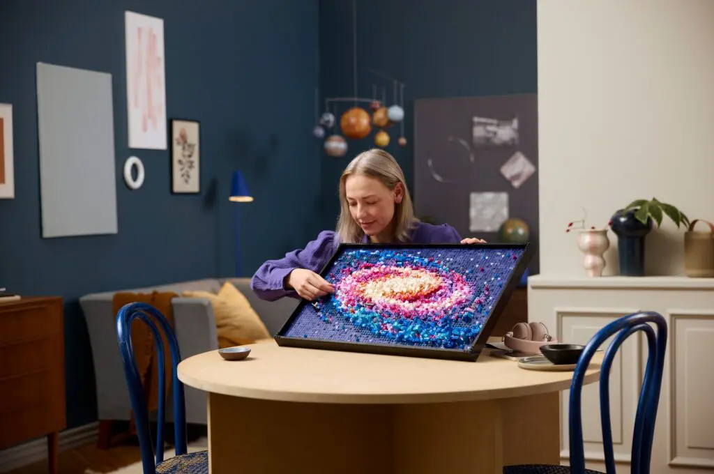 Woman holding colorful galaxy artwork